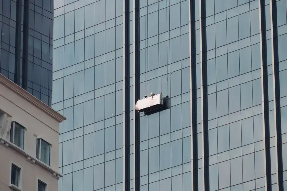 Professional cleaning a large commercial glass facade