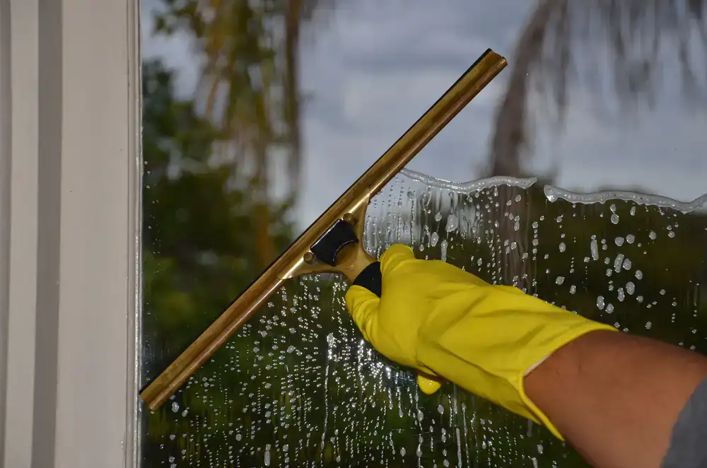 Close up of window cleaning using a professional squeegee