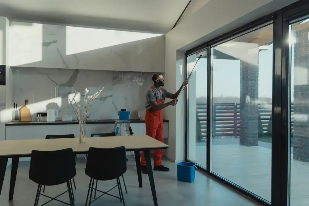 Close up of a professional squeegee cleaning a residential window